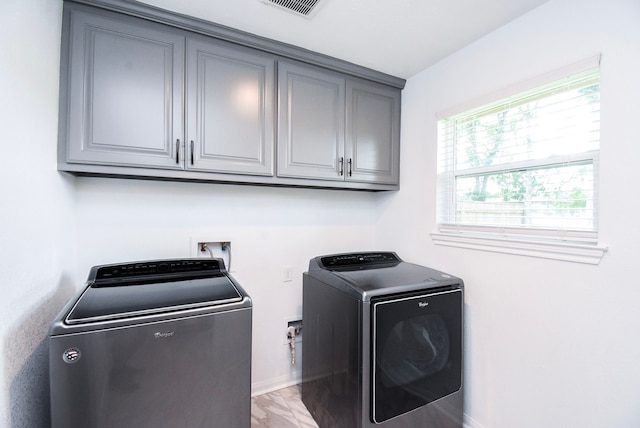 718 River Plantation Dr, Conroe, TX 77302 - washroom featuring separate washer and dryer, cabinet space, and healthy amount of natural light
