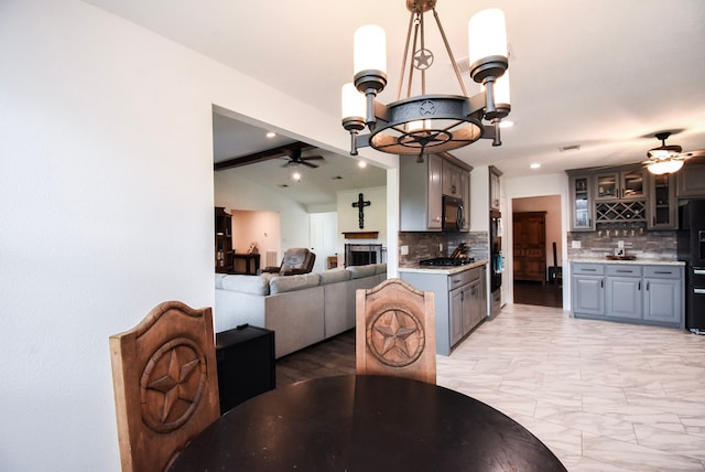 718 River Plantation Dr, Conroe, TX 77302 - dining room with a ceiling fan, a fireplace, bar with sink, light marble finish floors, and recessed lighting