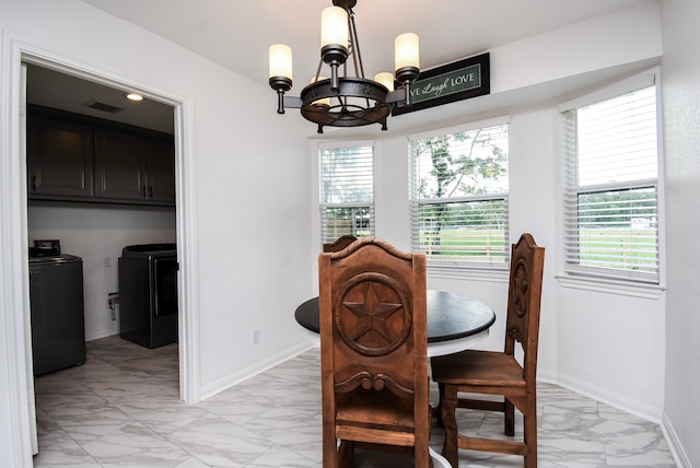 718 River Plantation Dr, Conroe, TX 77302 - dining room featuring light marble finish flooring, independent washer and dryer, and a chandelier