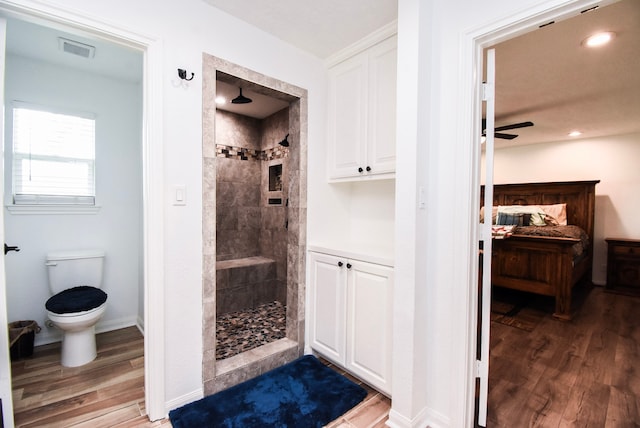 718 River Plantation Dr, Conroe, TX 77302 - full bath with wood finished floors, a tile shower, ceiling fan, and recessed lighting
