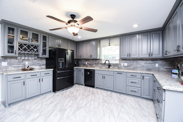 718 River Plantation Dr, Conroe, TX 77302 - kitchen featuring black appliances, gray cabinets, ceiling fan, decorative backsplash, and light marble finish floors