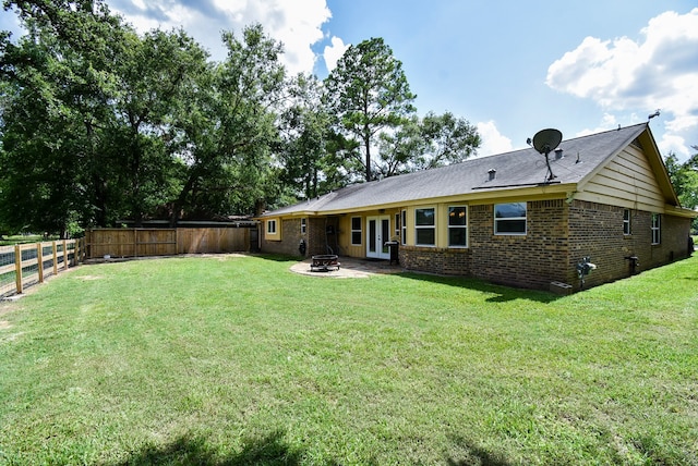 718 River Plantation Dr, Conroe, TX 77302 - back of house featuring a fenced backyard, brick siding, a fire pit, and french doors