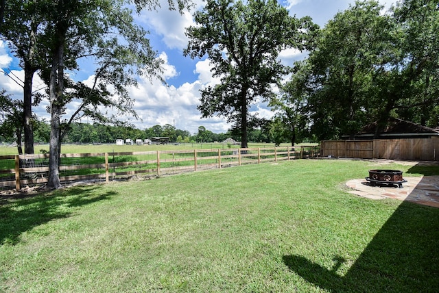 718 River Plantation Dr, Conroe, TX 77302 - view of yard featuring an outdoor fire pit and a view of rural / pastoral area