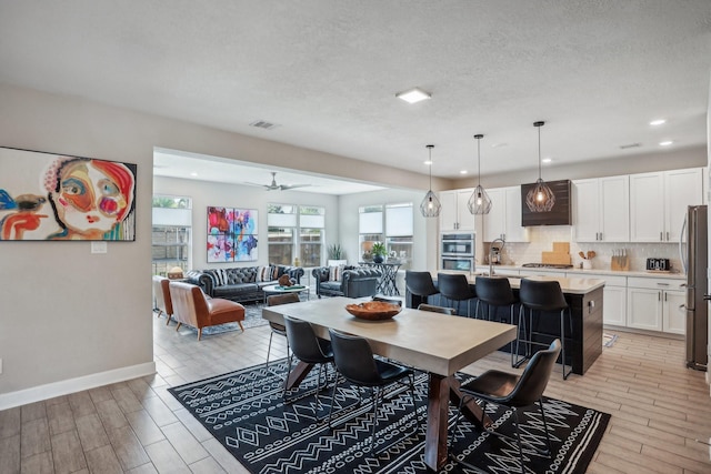 6019 Rivergrove Bend Dr, Humble, TX 77346 - dining room with light wood-style flooring, recessed lighting, ceiling fan, and a textured ceiling