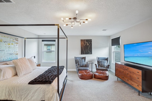 6019 Rivergrove Bend Dr, Humble, TX 77346 - bedroom with a chandelier, carpet floors, multiple windows, and a textured ceiling
