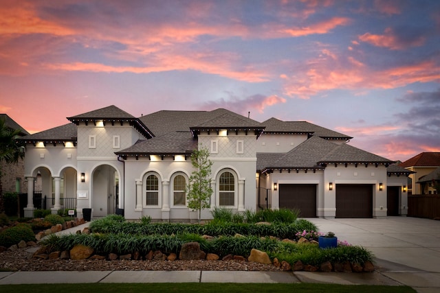3971 Rolling Thicket Dr, Spring, TX 77386 - mediterranean / spanish-style home featuring an attached garage, driveway, stucco siding, and a shingled roof