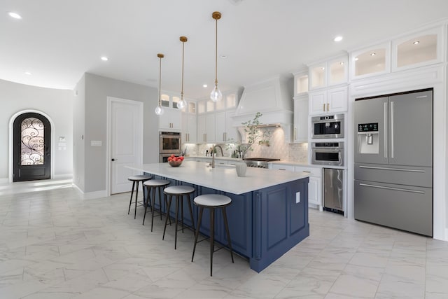 3971 Rolling Thicket Dr, Spring, TX 77386 - kitchen with stainless steel appliances, light marble finish flooring, wine cooler, light countertops, and tasteful backsplash
