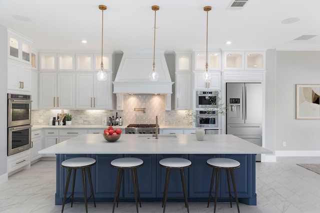 3971 Rolling Thicket Dr, Spring, TX 77386 - kitchen with appliances with stainless steel finishes, custom exhaust hood, light marble finish flooring, decorative backsplash, and light countertops