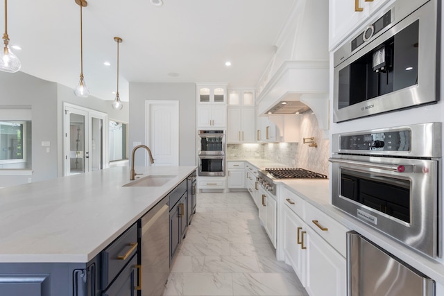 3971 Rolling Thicket Dr, Spring, TX 77386 - kitchen featuring appliances with stainless steel finishes, light marble finish flooring, white cabinetry, decorative backsplash, and pendant lighting