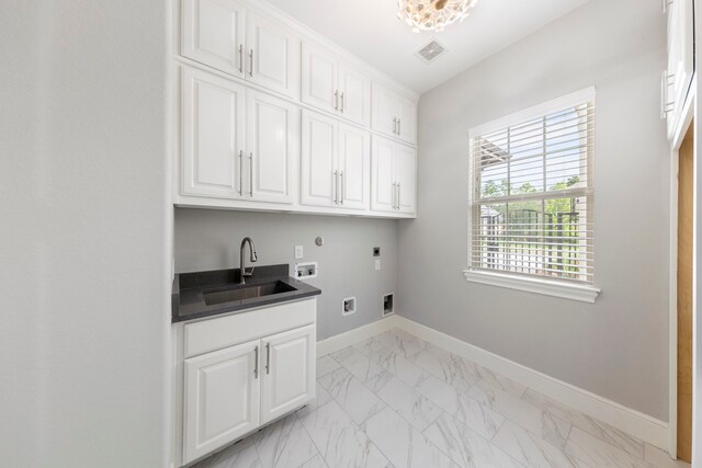 3971 Rolling Thicket Dr, Spring, TX 77386 - laundry room with hookup for an electric dryer, hookup for a washing machine, cabinet space, and light marble finish flooring