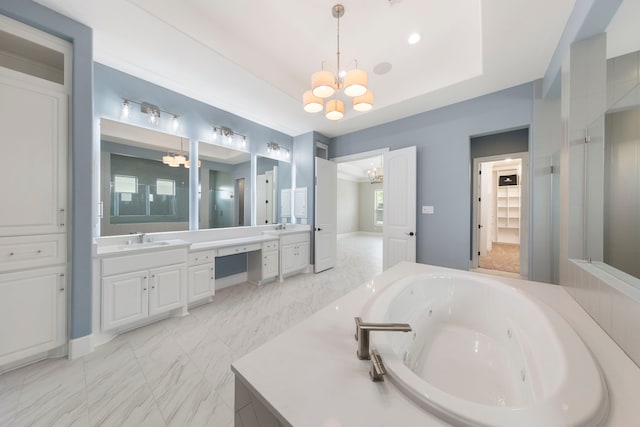 3971 Rolling Thicket Dr, Spring, TX 77386 - bathroom featuring a chandelier, vanity, a jetted tub, and marble finish flooring