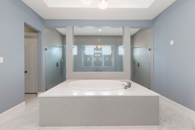 3971 Rolling Thicket Dr, Spring, TX 77386 - bathroom featuring a bath, a shower stall, and marble look tiles