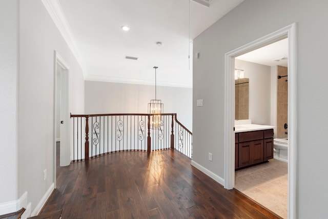 3971 Rolling Thicket Dr, Spring, TX 77386 - hall featuring crown molding, hardwood / wood-style flooring, a chandelier, and an upstairs landing