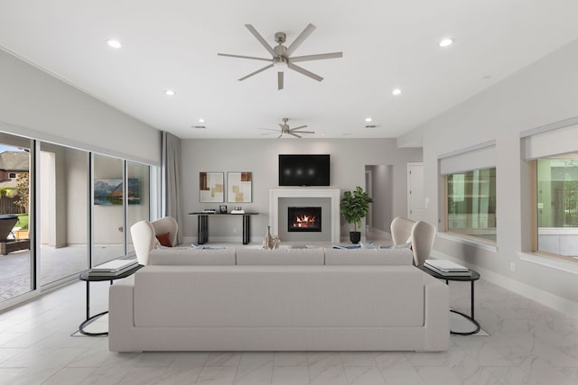 3971 Rolling Thicket Dr, Spring, TX 77386 - living area with ceiling fan, recessed lighting, a warm lit fireplace, and light marble finish floors