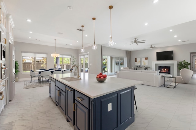 3971 Rolling Thicket Dr, Spring, TX 77386 - kitchen with light marble finish floors, recessed lighting, a lit fireplace, light countertops, and ceiling fan