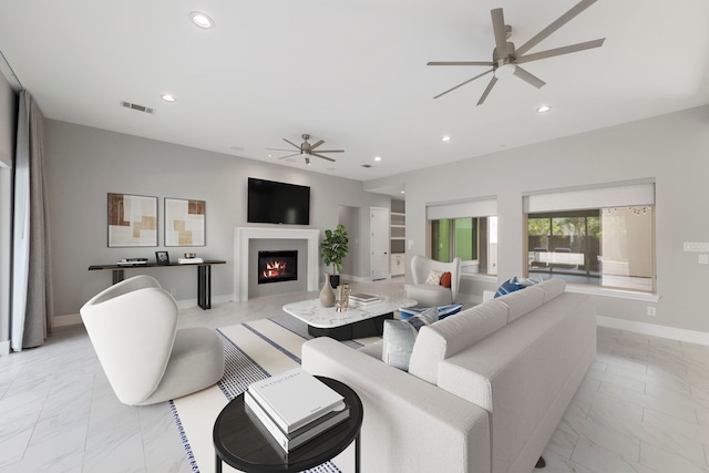 3971 Rolling Thicket Dr, Spring, TX 77386 - living area featuring ceiling fan, light marble finish flooring, recessed lighting, and a lit fireplace
