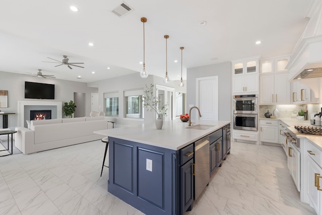 3971 Rolling Thicket Dr, Spring, TX 77386 - kitchen with stainless steel appliances, ceiling fan, light marble finish floors, white cabinetry, and blue cabinetry