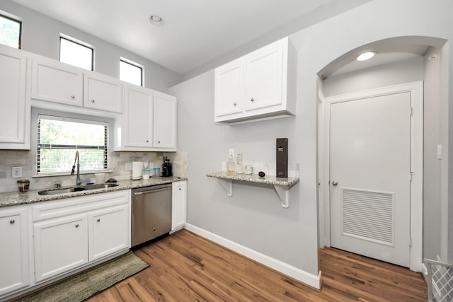 8710 Beverlyhill St Unit 201, Houston, TX 77063 - kitchen featuring stainless steel dishwasher, arched walkways, wood finished floors, white cabinets, and recessed lighting