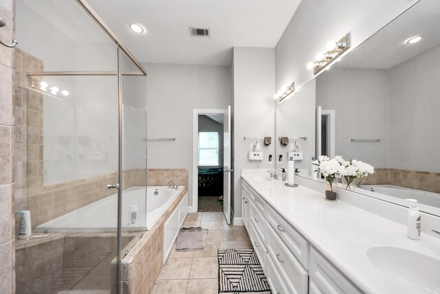 8710 Beverlyhill St Unit 201, Houston, TX 77063 - full bath featuring double vanity, a bath, a shower stall, tile patterned floors, and recessed lighting