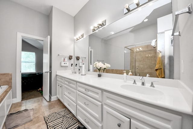8710 Beverlyhill St Unit 201, Houston, TX 77063 - full bath with double vanity, a stall shower, a garden tub, and tile patterned flooring