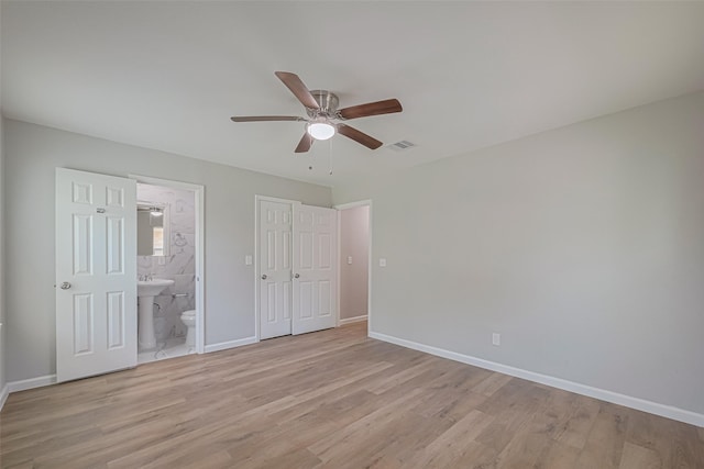 12210 Palmbeach St, Houston, TX 77034 - unfurnished bedroom featuring light wood-style floors, connected bathroom, ceiling fan, and a closet