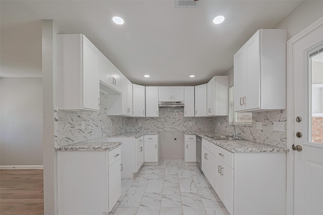 12210 Palmbeach St, Houston, TX 77034 - kitchen with under cabinet range hood, light stone countertops, recessed lighting, and decorative backsplash