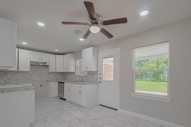12210 Palmbeach St, Houston, TX 77034 - kitchen with under cabinet range hood, ceiling fan, stainless steel dishwasher, light marble finish floors, and white cabinetry