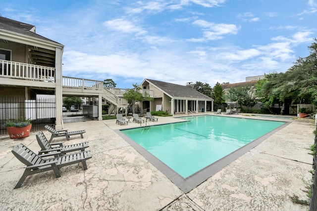2100 Tanglewilde St Unit 312, Houston, TX 77063 - community pool with stairway, a patio, an outbuilding, and a deck