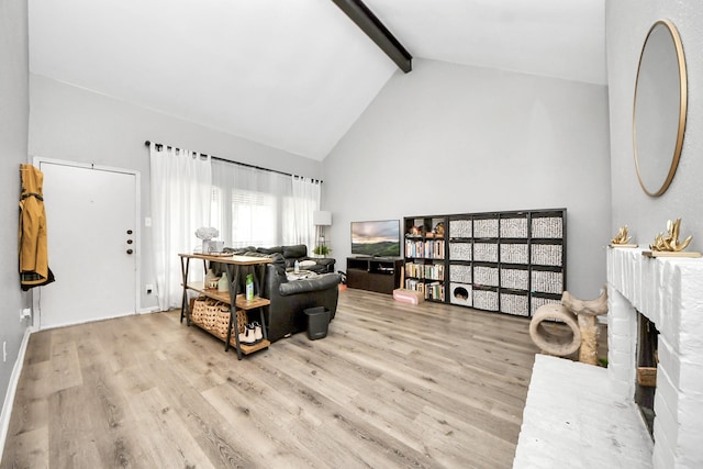 2100 Tanglewilde St Unit 312, Houston, TX 77063 - living room featuring beamed ceiling, wood finished floors, and high vaulted ceiling
