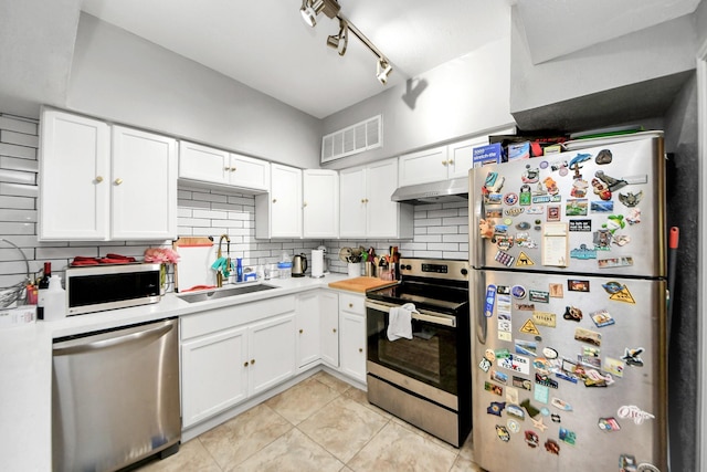 2100 Tanglewilde St Unit 312, Houston, TX 77063 - kitchen with appliances with stainless steel finishes, backsplash, light countertops, under cabinet range hood, and white cabinetry