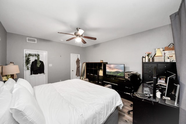 2100 Tanglewilde St Unit 312, Houston, TX 77063 - bedroom with wood finished floors, an office area, and a ceiling fan