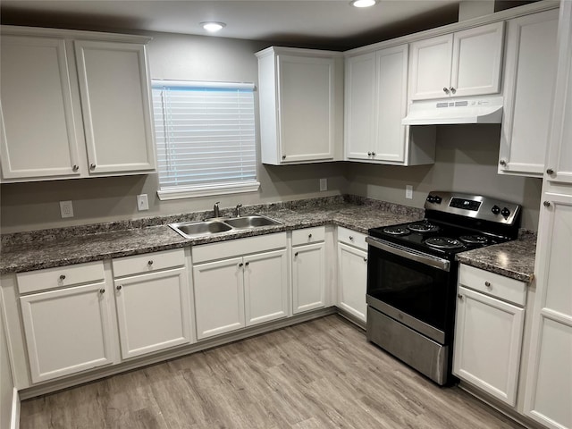 5105 Oak Ave, Pasadena, TX 77503 - kitchen with electric range, under cabinet range hood, white cabinets, light wood-style floors, and recessed lighting