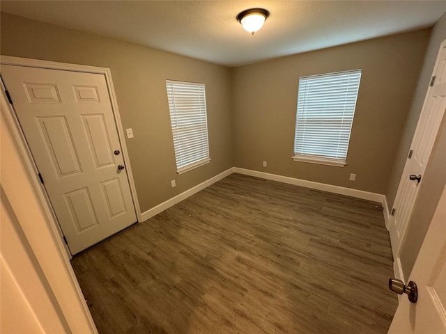5105 Oak Ave, Pasadena, TX 77503 - spare room with baseboards and dark wood-style floors