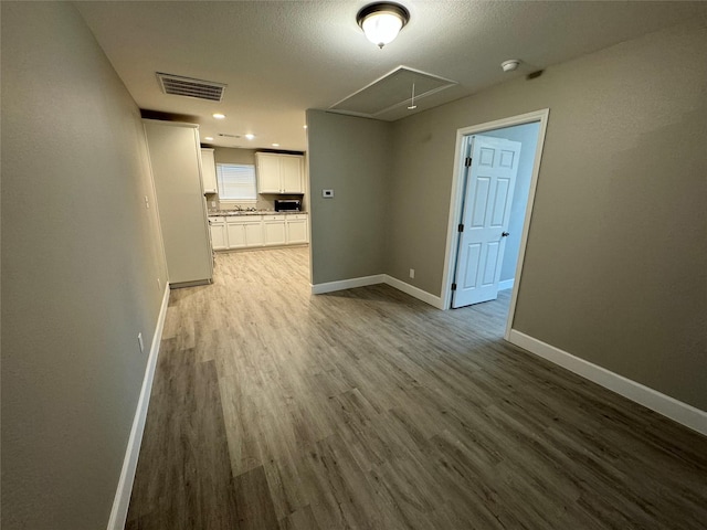 5105 Oak Ave, Pasadena, TX 77503 - spare room with attic access, dark wood-type flooring, a smoke detector, and recessed lighting