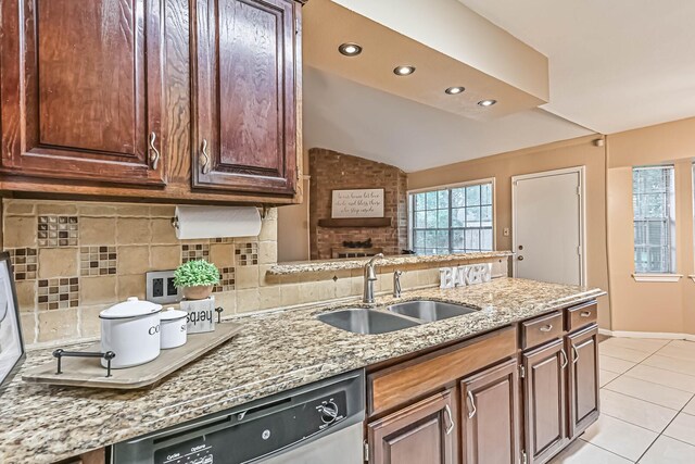 55 Sweetgum Ct, Lake Jackson, TX 77566 - kitchen featuring dishwasher, light tile patterned flooring, tasteful backsplash, light stone counters, and lofted ceiling