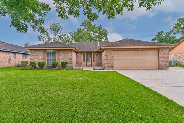 55 Sweetgum Ct, Lake Jackson, TX 77566 - view of front facade featuring an attached garage, driveway, a front lawn, and brick siding