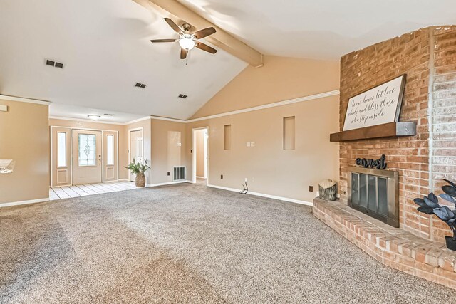 55 Sweetgum Ct, Lake Jackson, TX 77566 - unfurnished living room with ceiling fan, beamed ceiling, a brick fireplace, carpet floors, and high vaulted ceiling