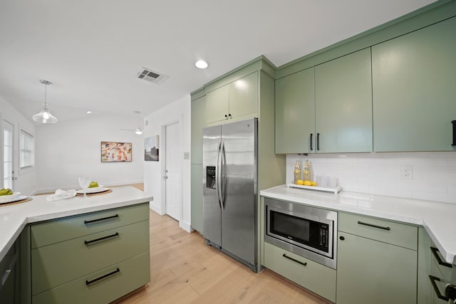 5730 Chrystell Ln, Houston, TX 77092 - kitchen with green cabinetry, appliances with stainless steel finishes, light wood-style floors, light countertops, and recessed lighting
