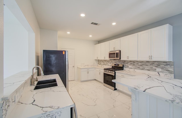 4627 Prairie Chase Dr, Houston, TX 77069 - kitchen featuring appliances with stainless steel finishes, light stone counters, light marble finish flooring, decorative backsplash, and recessed lighting