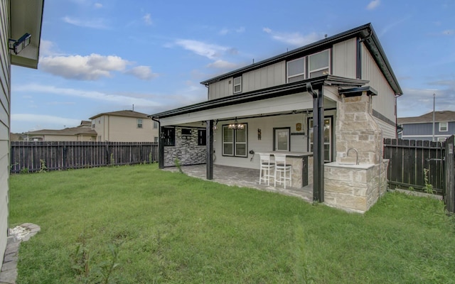 4627 Prairie Chase Dr, Houston, TX 77069 - rear view of property with a fenced backyard, a patio, and stone siding