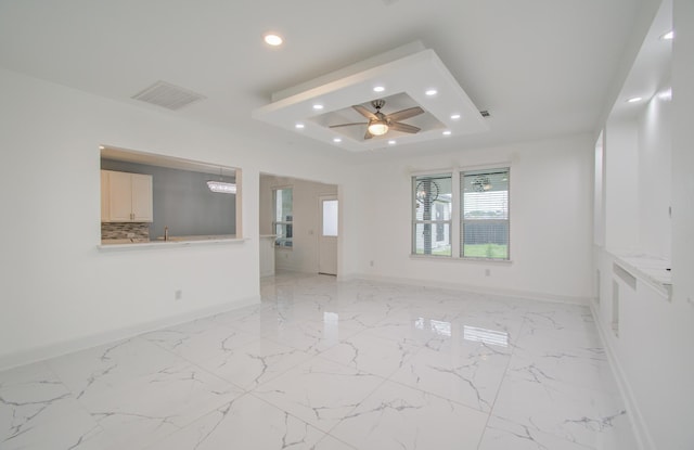 4627 Prairie Chase Dr, Houston, TX 77069 - empty room featuring recessed lighting, ceiling fan, a tray ceiling, and light marble finish flooring