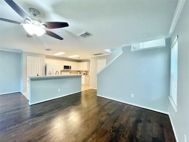 46 Marble Rock Pl, The Woodlands, TX 77382 - unfurnished living room featuring ornamental molding, ceiling fan, and dark wood finished floors