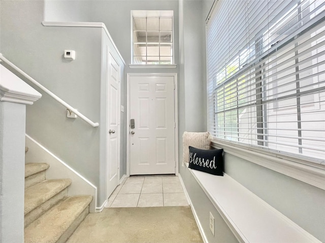 46 Marble Rock Pl, The Woodlands, TX 77382 - foyer with light colored carpet, light tile patterned floors, stairs, and plenty of natural light