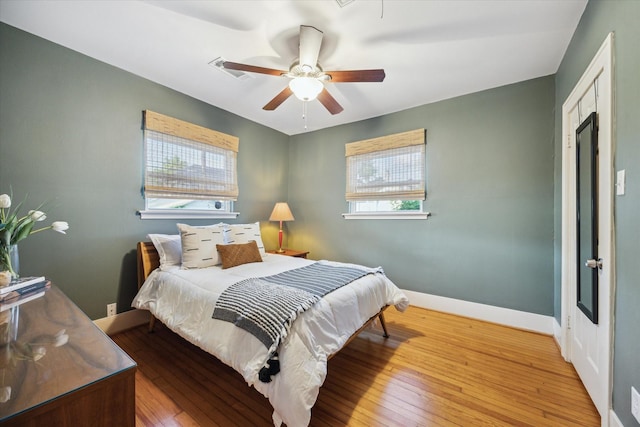 711 Pizer St, Houston, TX 77009 - bedroom with multiple windows, hardwood / wood-style flooring, and a ceiling fan