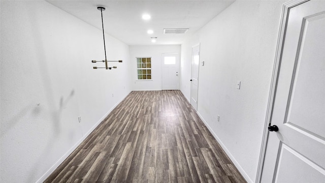 2235 Hutton St, Houston, TX 77026 - hallway with dark wood-style floors and a chandelier