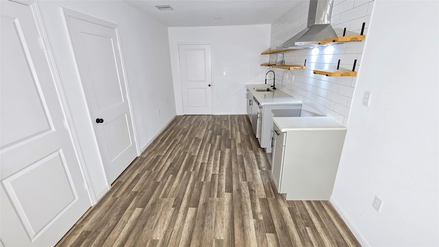 2235 Hutton St, Houston, TX 77026 - kitchen featuring open shelves, dark wood-style flooring, light countertops, wall chimney exhaust hood, and white cabinetry