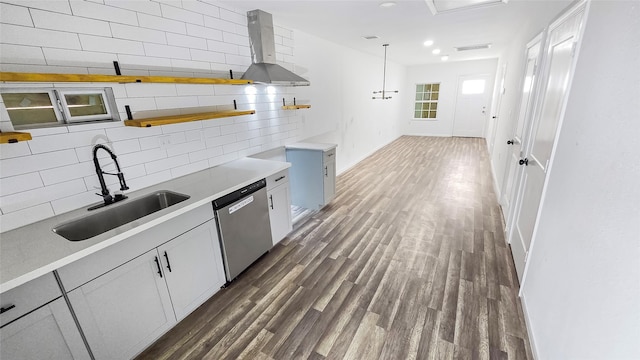 2235 Hutton St, Houston, TX 77026 - kitchen with dishwasher, backsplash, wall chimney range hood, dark wood-type flooring, and light countertops
