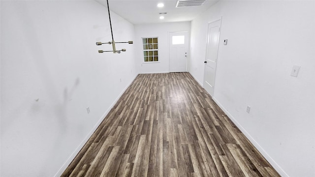 2235 Hutton St, Houston, TX 77026 - hall featuring wood finished floors and a chandelier