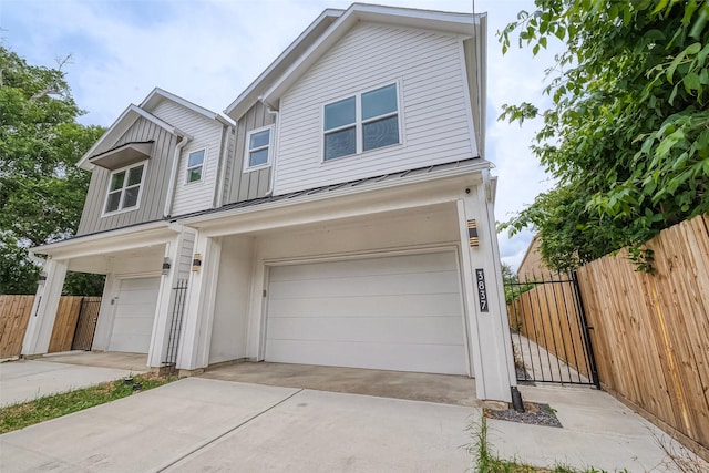 3835 Mainer St, Houston, TX 77021 - view of front facade featuring an attached garage, board and batten siding, and concrete driveway