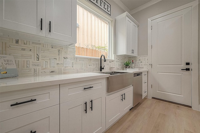 3835 Mainer St, Houston, TX 77021 - kitchen with dishwasher, tasteful backsplash, ornamental molding, white cabinetry, and light wood-style flooring